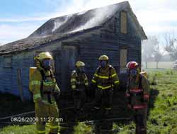 4 firefighters fighting a house fire